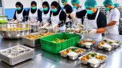 Ketgam: Ilustrasi aktivitas penyediaan dan pengemasan makanan dalam program Makan Bergizi Gratis (MBG) di dapur Satuan Pelayanan Pemenuhan Gizi (SPPG). Sejumlah SPPG di Kabupaten Bone dilaporkan menghentikan operasional sementara akibat terkendala pendanaan. (Ilustrasi/AI)